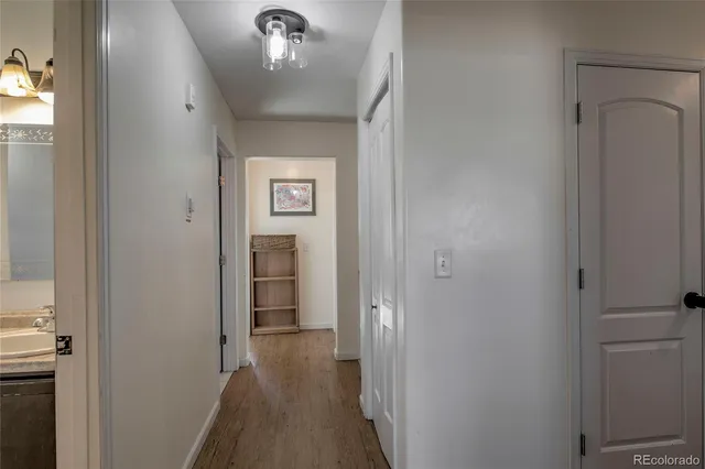 a view of a hallway with wooden floor