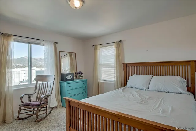 a bedroom with a bed and a view of balcony