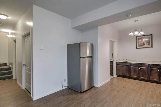 a kitchen with stainless steel appliances granite countertop a refrigerator and a stove top oven