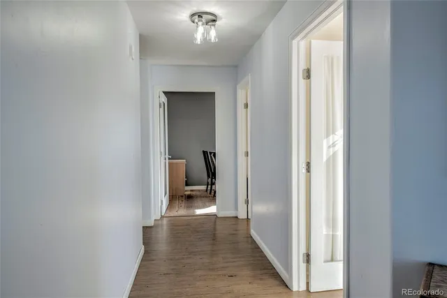 a view of a hallway with a room that has a bed