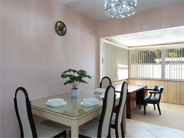 a view of a dining room with furniture and a large window