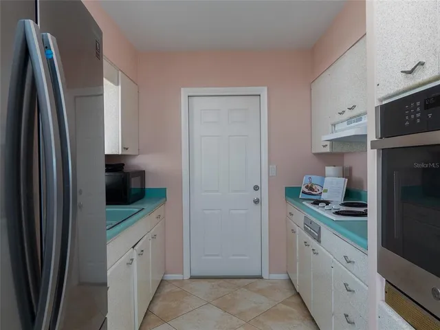 a kitchen with stainless steel appliances a refrigerator sink and stove