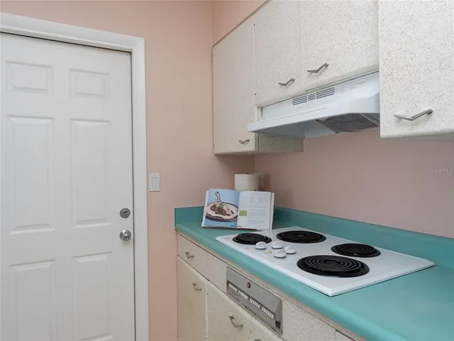 a kitchen with a stove and cabinets