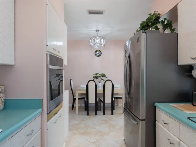 a view of a refrigerator and kitchen