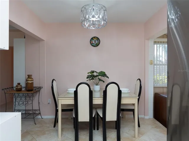 a view of a dining room with furniture and chandelier