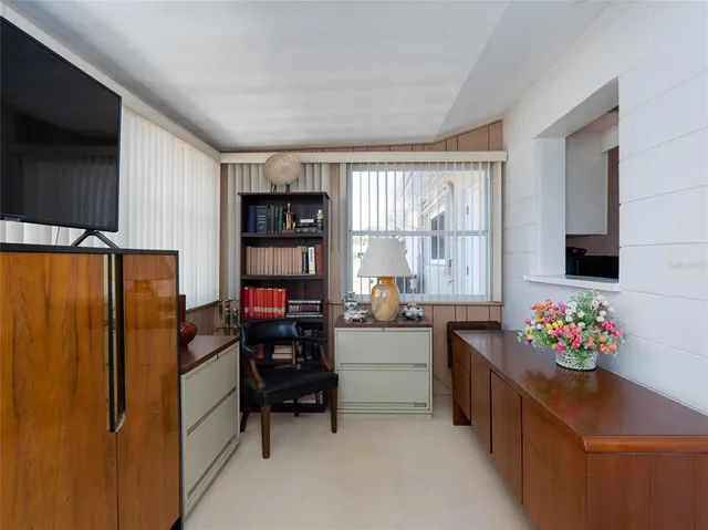 a kitchen that has a refrigerator and a table in it