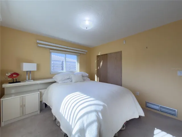 a bedroom with a bed and a closet