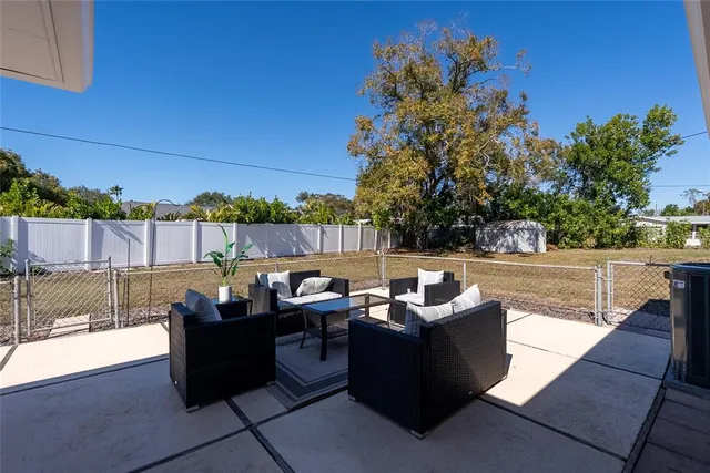 a outdoor sitting area with furniture and a potted plant