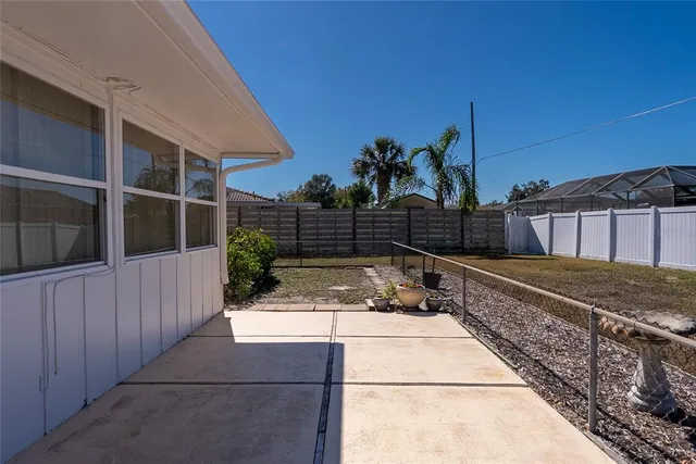 a view of a backyard with wooden fence