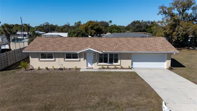 a aerial view of a house with a yard and a garage