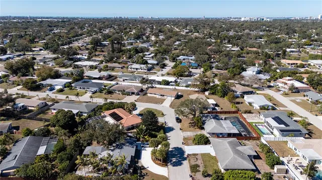 an aerial view of residential building with parking