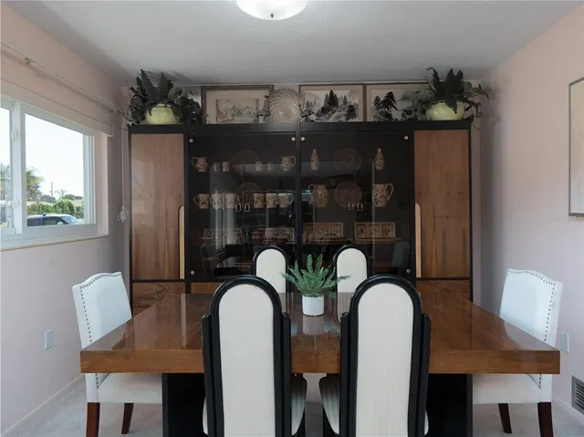 a dining room with furniture and chandelier
