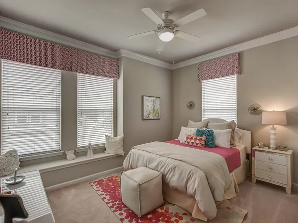 a spacious bedroom with a bed and a large window
