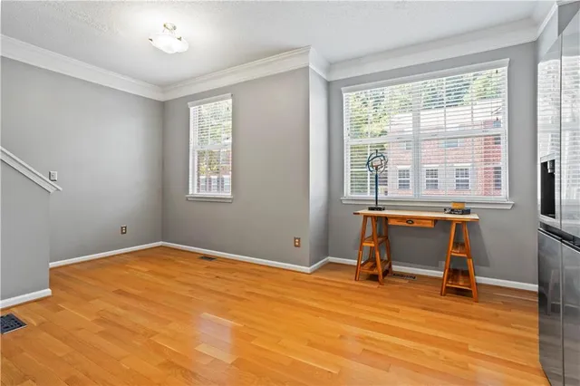 a workspace with wooden floor and a window