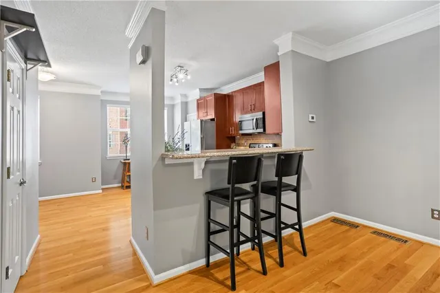 a view of kitchen and dining room with wooden floor