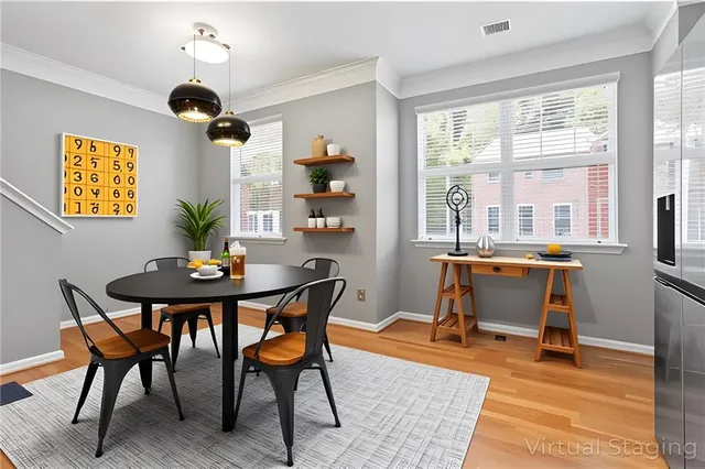 a view of a dining room with furniture window and wooden floor