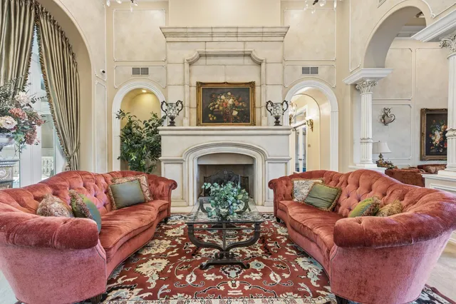 a living room with furniture a fireplace and a rug