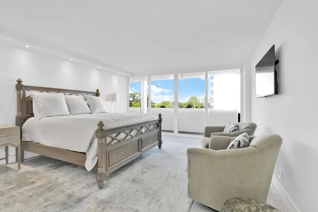 a bedroom with a bed and a table