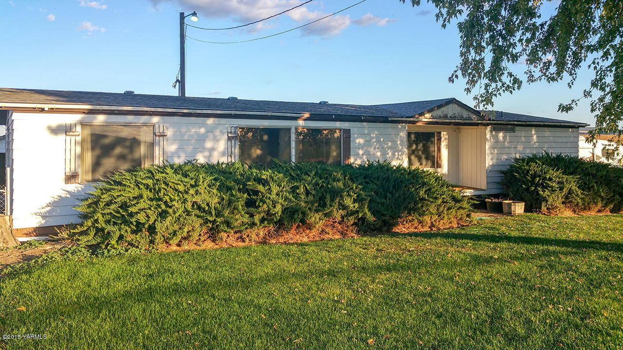 931 Liberty Road Outlook, WA 98938 - Photo 1 of 12 a front view of a house with a yard and potted plants
