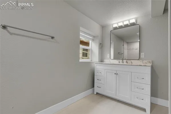 a bathroom with a double vanity sink and a mirror