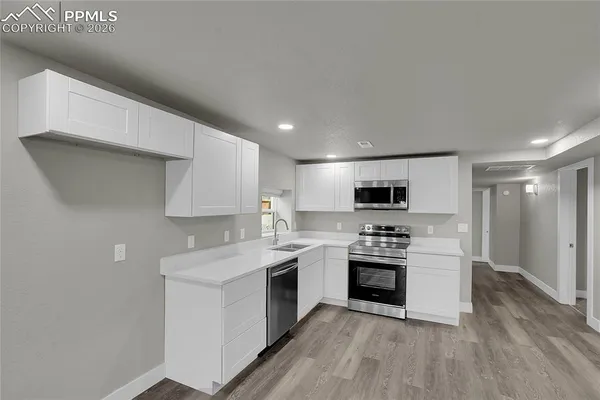 a kitchen with a stove top oven and cabinets