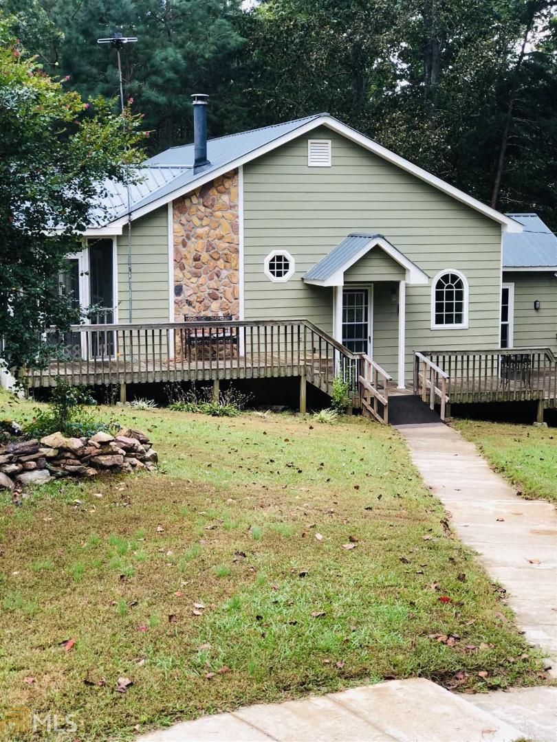 a view of a house with a yard in the background