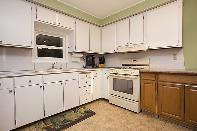 1255 Country Club Road Elgin, IL 60123 - Photo 8 of 20 a kitchen with granite countertop white cabinets and white appliances