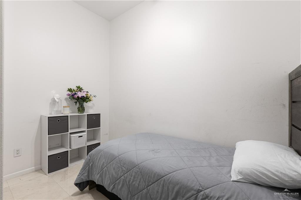 514 Rio Grande Drive Mission, TX 78572 - Photo 21 of 28 a bedroom with a bed and a potted plant