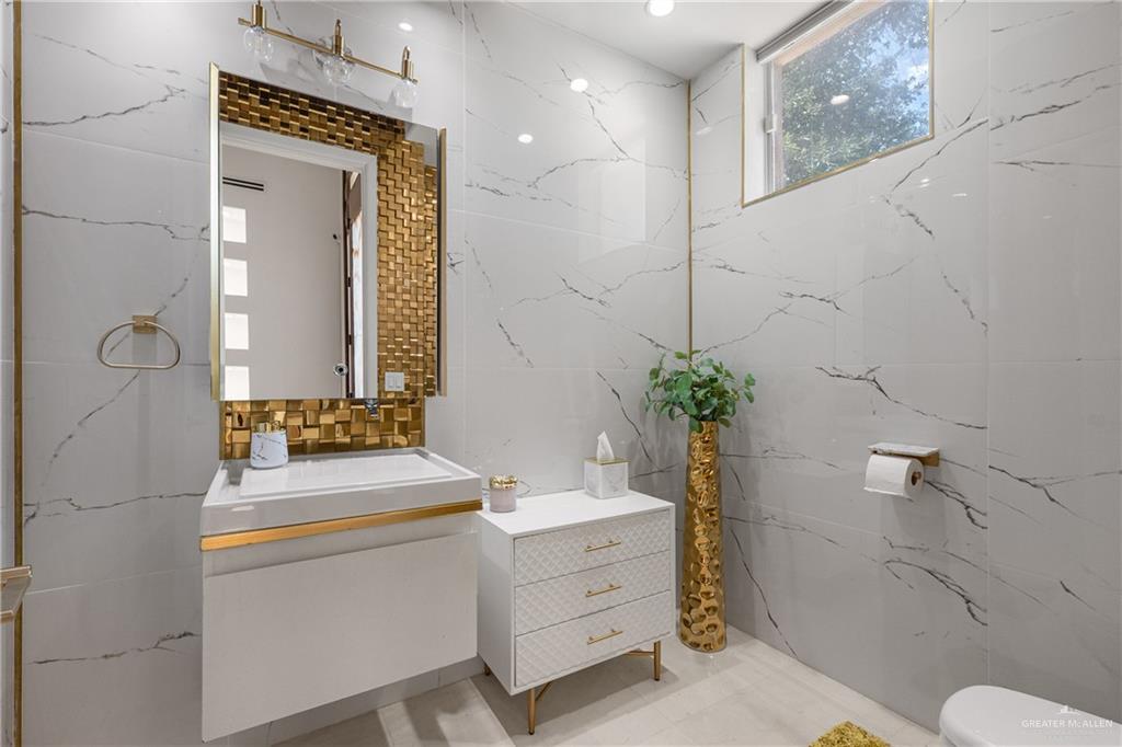 514 Rio Grande Drive Mission, TX 78572 - Photo 10 of 28 a bathroom with a sink a toilet and mirror