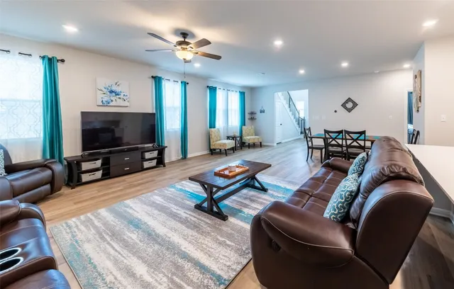 a living room with furniture and wooden floor