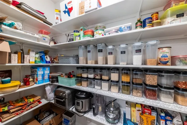 a kitchen with granite countertop a sink a stove and cabinets