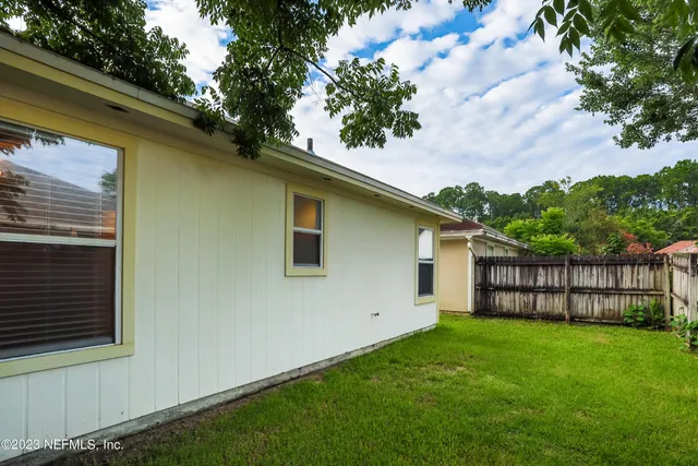a yellow house sitting in middle of the grass
