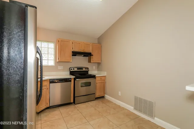 a kitchen with a sink stainless steel appliances and cabinets