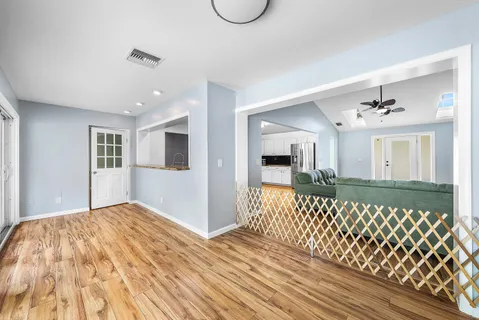 an empty room with a window and a ceiling fan