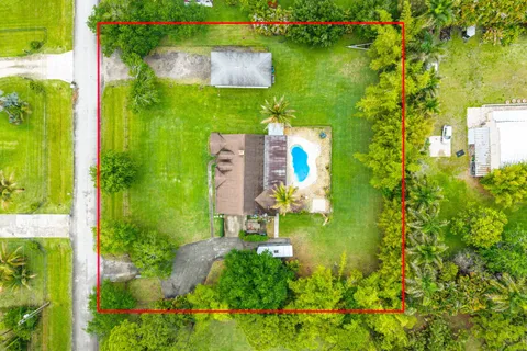 an aerial view of residential houses with outdoor space and swimming pool