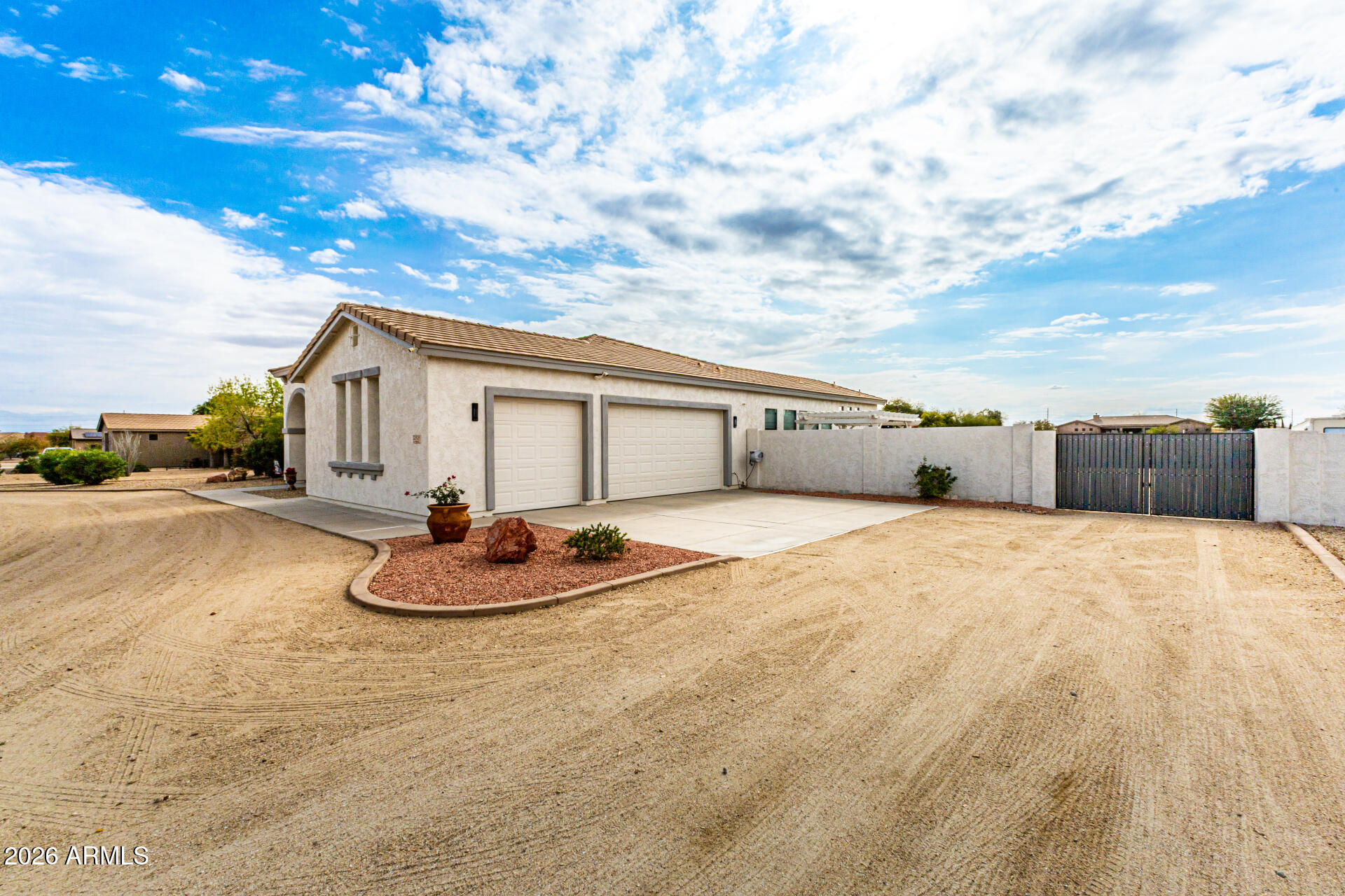 22909 West Sierra Ridge Way Wittmann, AZ 85361 - Photo 20 of 121 a backyard of a house with table and chairs