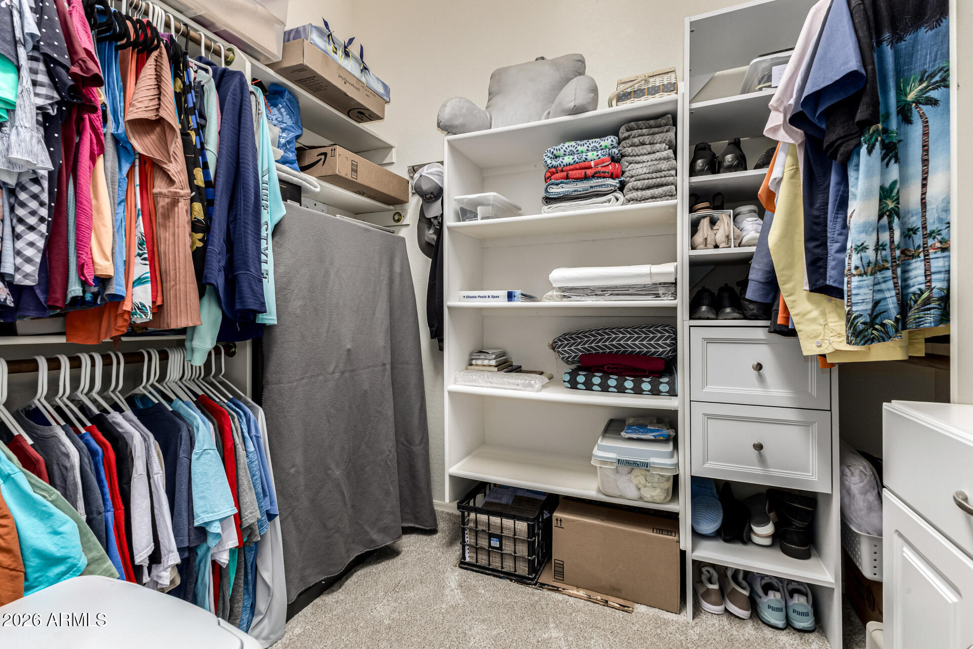 22909 West Sierra Ridge Way Wittmann, AZ 85361 - Photo 46 of 121 a view of walk in closet with clothes and shoes