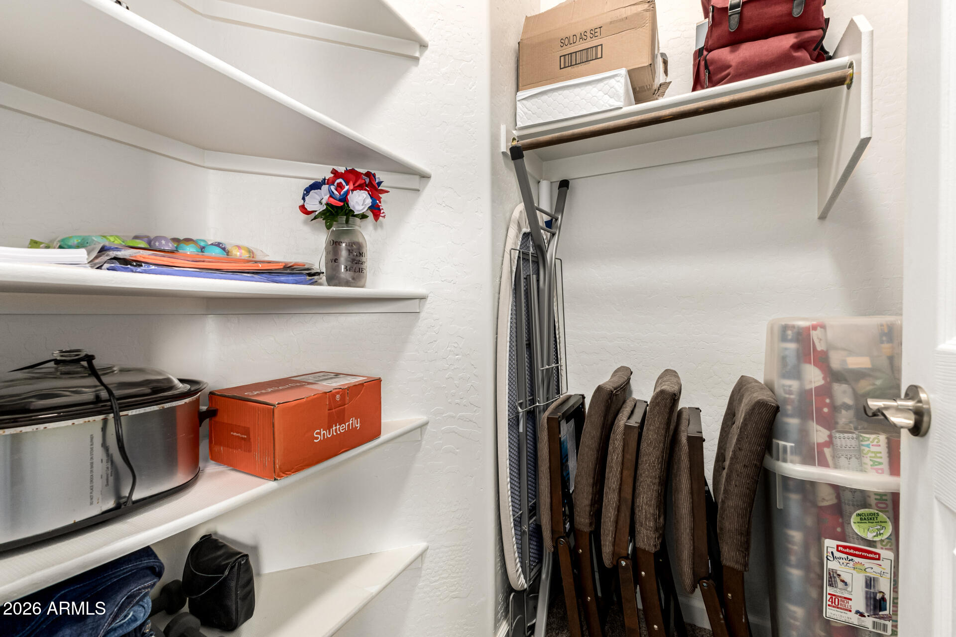 22909 West Sierra Ridge Way Wittmann, AZ 85361 - Photo 59 of 121 a view of walk in closet with clothes and shoes