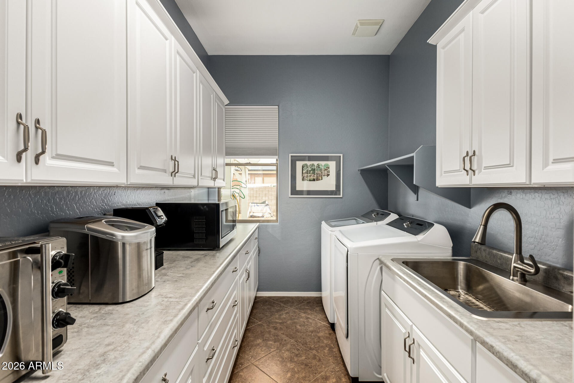 22909 West Sierra Ridge Way Wittmann, AZ 85361 - Photo 63 of 121 a kitchen with a sink and a stove top oven