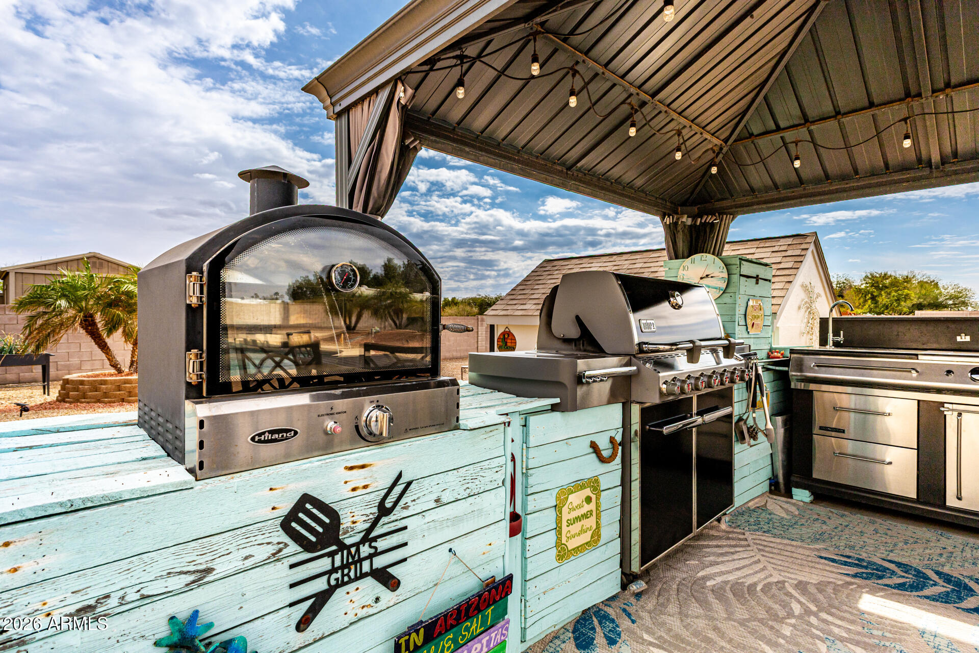 22909 West Sierra Ridge Way Wittmann, AZ 85361 - Photo 69 of 121 a view of open kitchen with stainless steel appliances wooden floor and chandelier