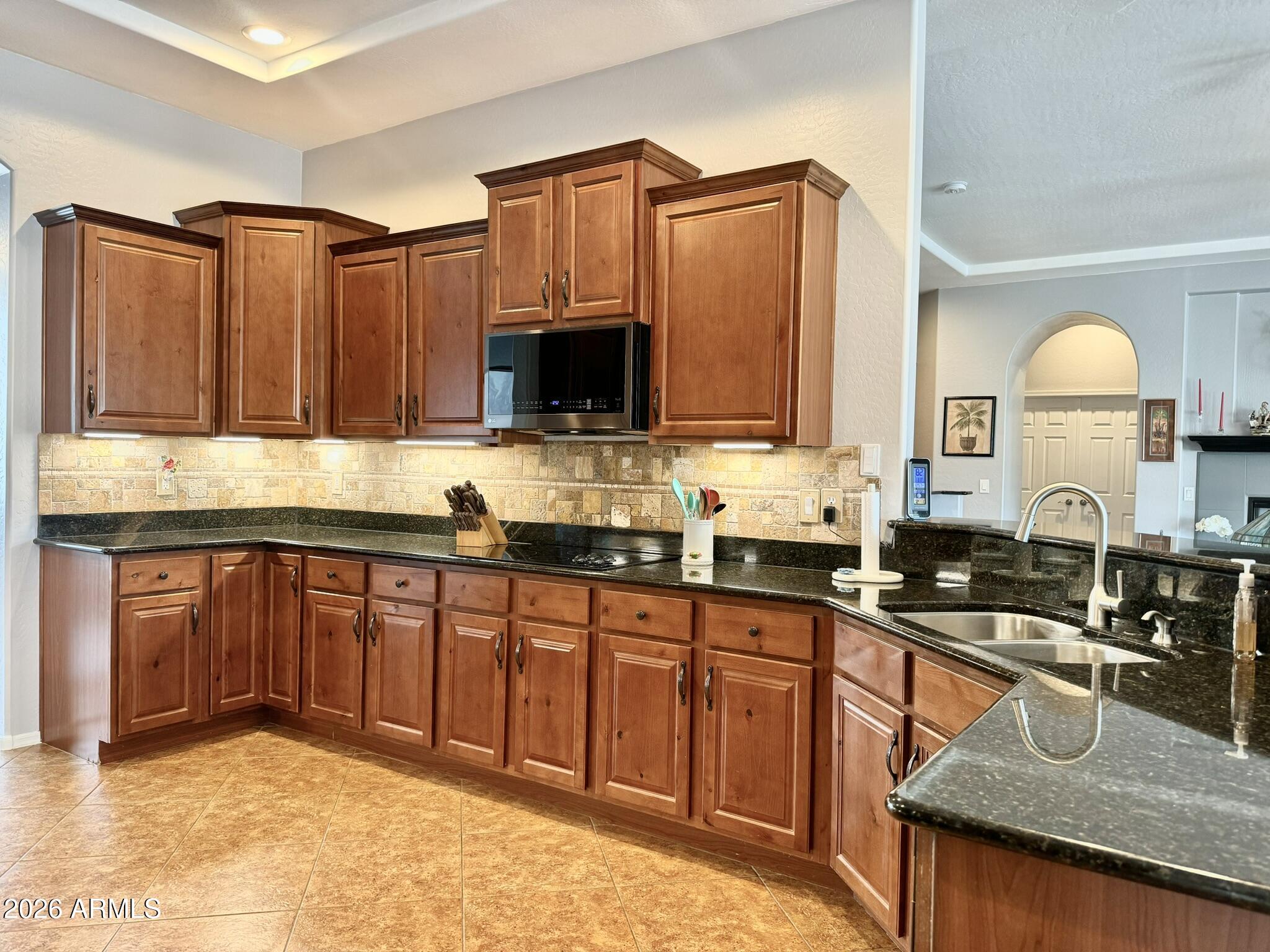 22909 West Sierra Ridge Way Wittmann, AZ 85361 - Photo 88 of 121 a kitchen with stainless steel appliances granite countertop a sink a stove counter space and cabinets