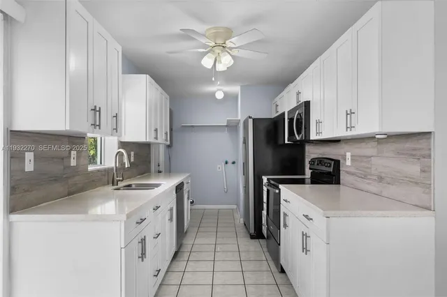 a kitchen with a sink stove and refrigerator