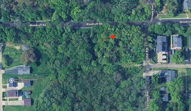 a backyard of a house with lots of green space and a fountain