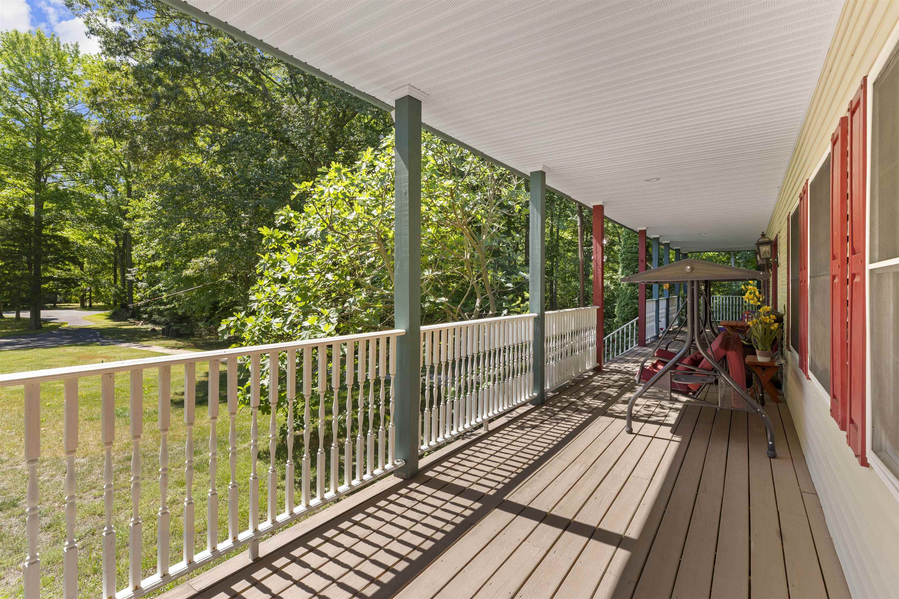 551 Shunpike Road Cape May Court House, NJ 08210 - Photo 35 of 47 a view of balcony with chairs and wooden floor