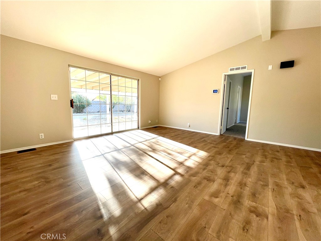 12546 Navajo Road Apple Valley, CA 92308 - Photo 4 of 27 Large living room leads to a covered patio with plenty of space for outdoor living.