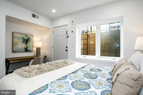 a bedroom with a bed and a window