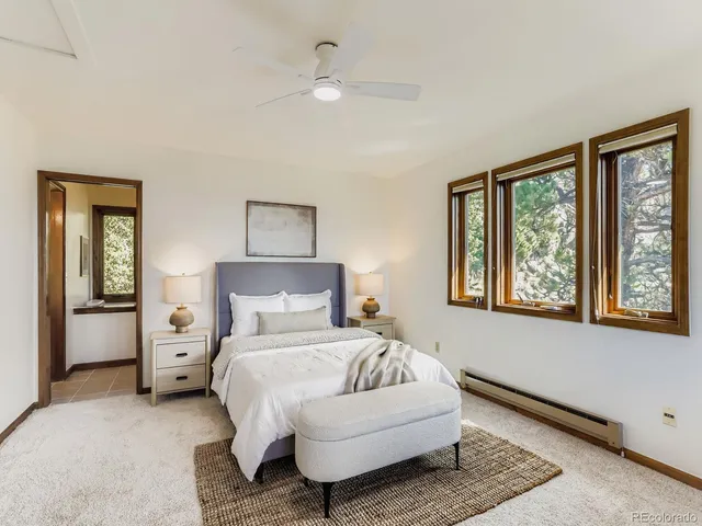 a bedroom with a large bed and a window