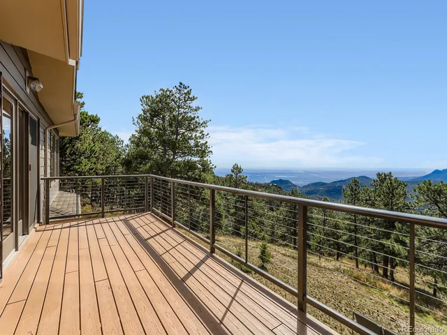 a view of balcony with wooden floor and fence