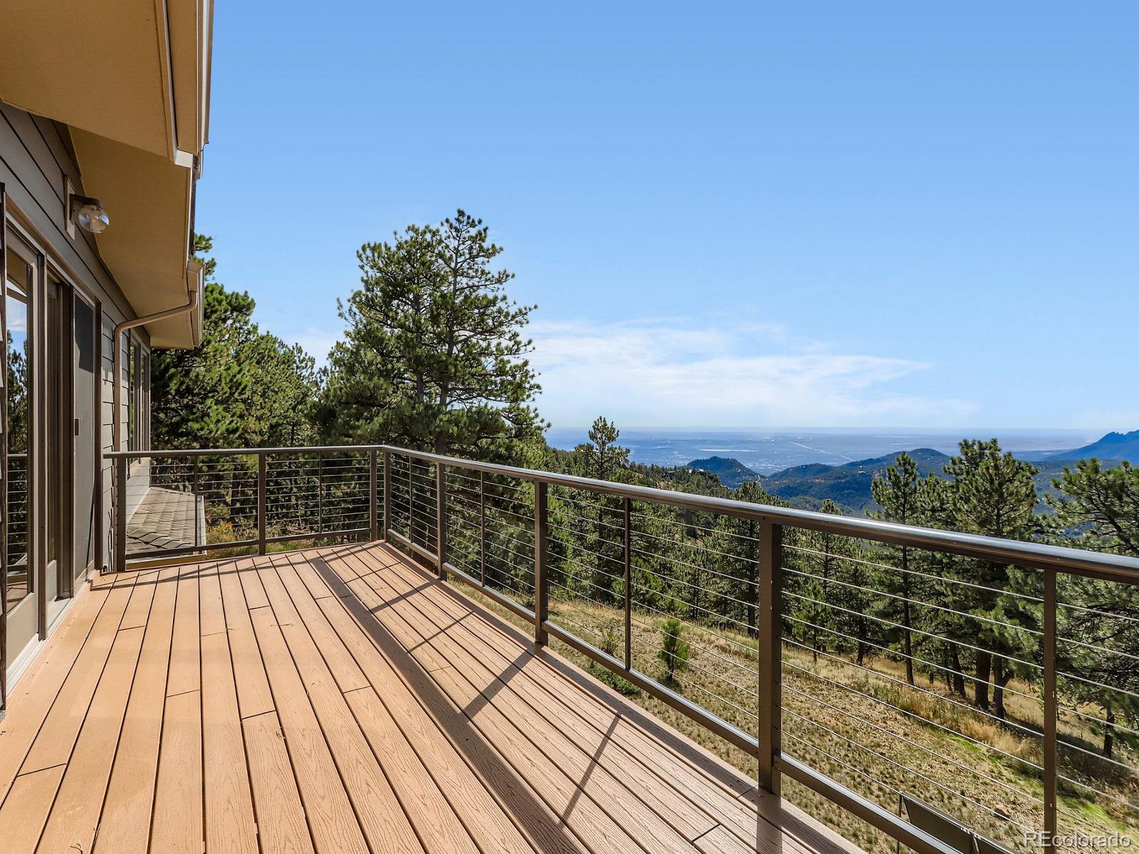 677 Sky Trail Road Boulder, CO 80302 - Photo 3 of 40 a view of balcony with wooden floor and fence