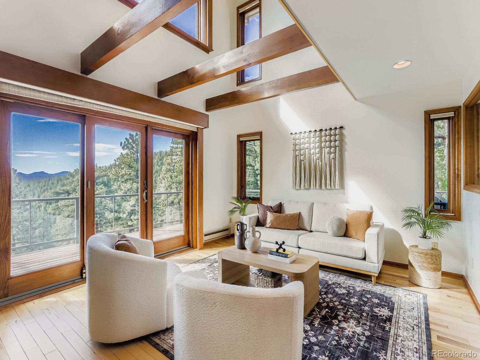 677 Sky Trail Road Boulder, CO 80302 - Photo 5 of 40 a living room with furniture and a large window